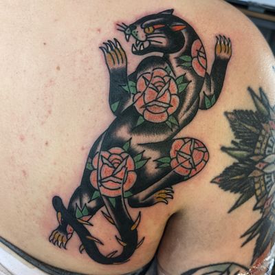 Get inked by Benji Charnock with this classic design featuring a fierce panther and delicate flower motif.