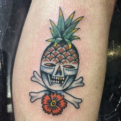 Get inked by Benji Charnock with this unique traditional tattoo featuring a skull and pineapple motif. Perfect blend of edgy and tropical vibes!