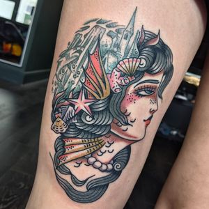 Stunning traditional tattoo of a woman, expertly done by renowned artist Benji Charnock. Bold lines and vibrant colors bring this artwork to life.