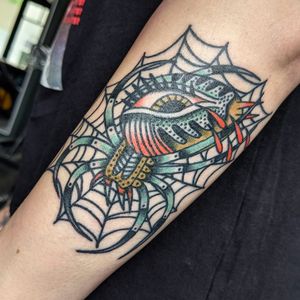 Get inked with a classic spider design in traditional style by the talented artist Benji Charnock.