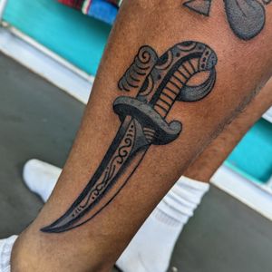 Get inked by Benji Charnock with a classic traditional knife design that's as sharp as it looks. Perfect for those who crave a bold and timeless tattoo.