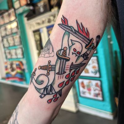 Get inked with this striking traditional tattoo featuring a sword and ghost motif by the talented artist Benji Charnock.