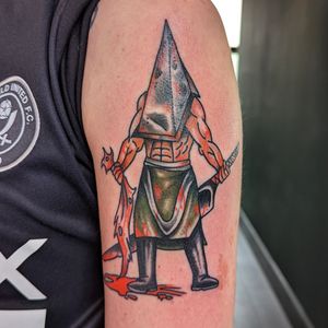 Traditional tattoo featuring the iconic Pyramid Head character from the game Silent Hill, done by artist Benji Charnock.