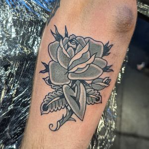 Experience timeless beauty with this traditional rose tattoo design by the talented artist Benji Charnock.