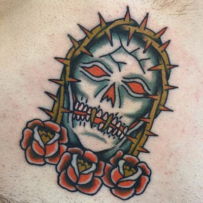Embrace the classic look with this traditional skull tattoo done by the talented artist Benji Charnock. A timeless piece for your ink collection.