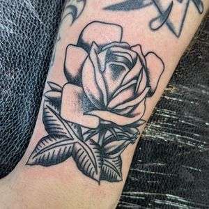 A timeless traditional tattoo featuring a stunning rose design by the talented artist Benji Charnock. Perfect for those who appreciate classic beauty.