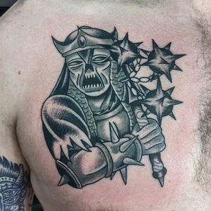 Embrace your inner warrior with a traditional tattoo by artist Benji Charnock, featuring intricate detailing and bold colors.