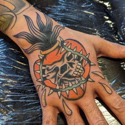 Get inked by the talented Benji Charnock with this stunning traditional design featuring a skull and sacred heart motif. Perfect for those looking for a bold and classic tattoo!