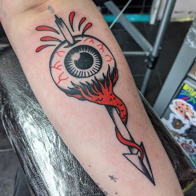 Intriguing traditional tattoo design featuring an arrow and eye by talented artist Benji Charnock. Perfect for those seeking a bold and symbolic piece of body art.