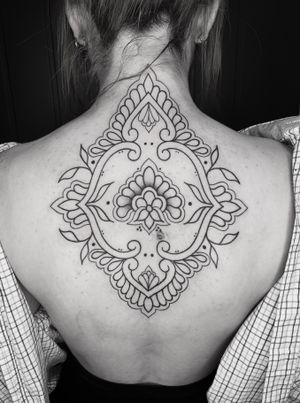 Experience the beauty of ornamental art with this stunning mandala tattoo designed by TattsByBetts.