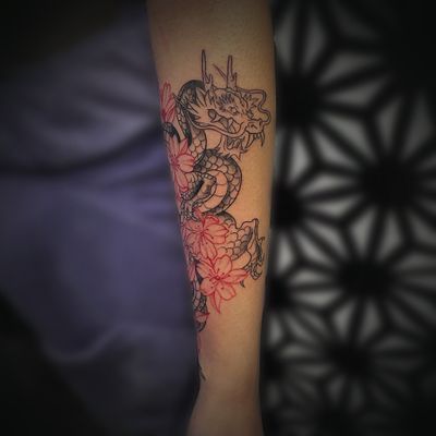 Black and grey dragon with red cherry blossoms flowers