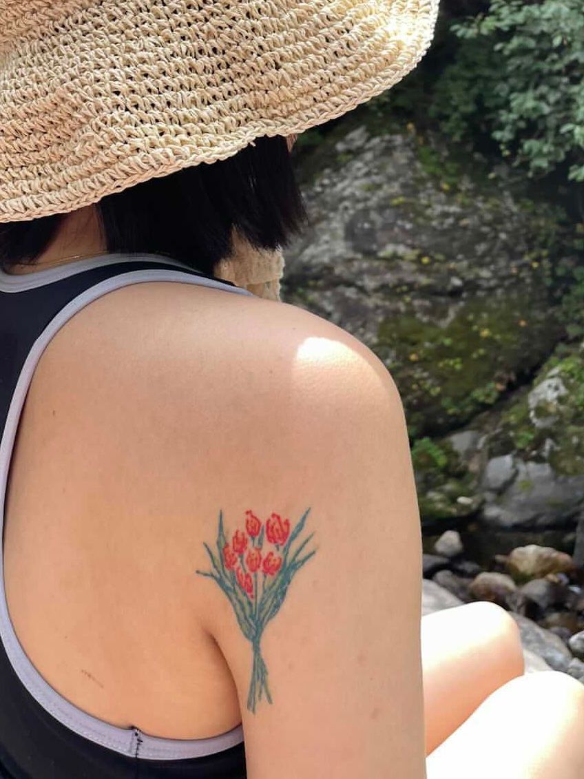 Little peony tattoo located on the wrist.