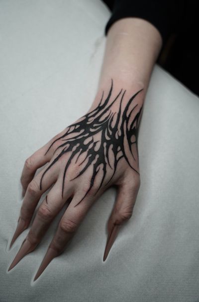 Experience the fusion of ancient tribal motifs with futuristic cyber sigils in this unique tattoo by Dominga Longo.