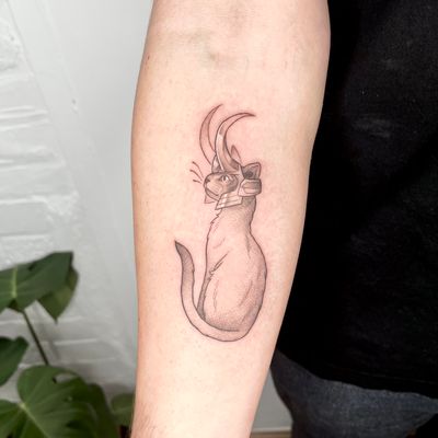 Capture your beloved feline friend with this unique illustrative tattoo by Michelle Harrison. Perfect for pet lovers and fans of Loki!