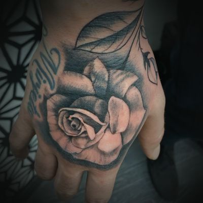 Black and grey Hand rose flower tattoo 