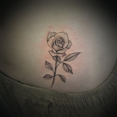 Fine line delicate rose flower on hip