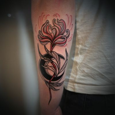 Red spider lily flower with black crescent moon and plant