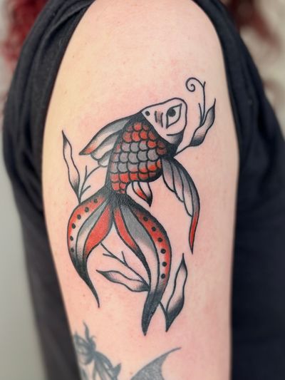 Explore the beauty of traditional tattoo art with this stunning fish motif designed by talented artist Clara Colibri.