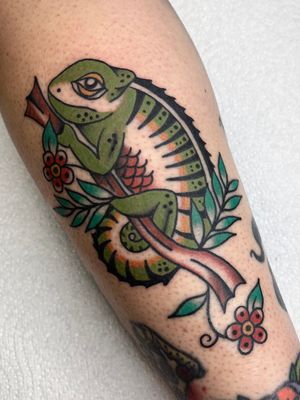 Experience the vibrant world of traditional tattooing with a stunning chameleon design by the talented artist Clara Colibri.