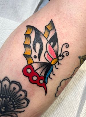 Embrace the timeless beauty of a traditional butterfly tattoo expertly crafted by Clara Colibri.