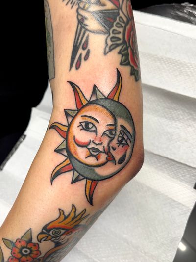 Get a stunning traditional tattoo of sun and moon by Clara Colibri, blending mystical elements in perfect harmony.