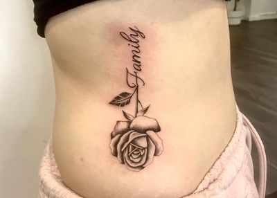 Show your love for family with this delicate lettering tattoo featuring a beautiful rose design. Done by Epic Tattoos Guildford.