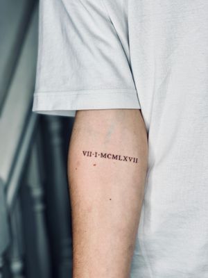Get a timeless and elegant roman small lettering tattoo designed by the talented artist Tal. Perfect for a subtle and sophisticated touch.