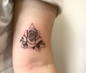 Get a stunning floral and illustrative tattoo featuring a rose and triangle motif by Epic Tattoos Guildford.