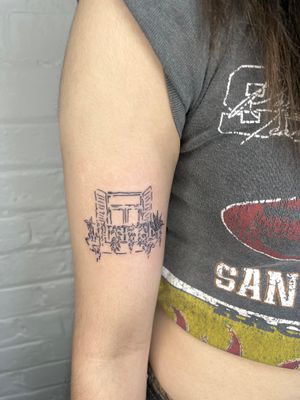 Get mesmerized by Emily Bonnet's illustrative tattoo featuring a stunning window and balcony design.