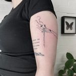 A beautifully detailed fine line tattoo of a bird perched on an electric post, designed by Emily Bonnet.