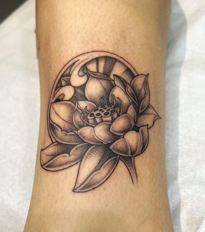 Embrace the beauty of nature with this stunning lotus flower tattoo, expertly executed by the talented artist Ben Prescott.