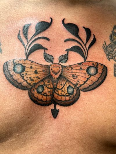 Get inked with a stunning neo-traditional moth design by Ben Prescott, combining bold lines and vibrant colors.