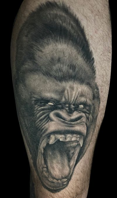 Experience the power and grace of a gorilla in this striking black and gray realism tattoo by the talented artist Pete Bienge.