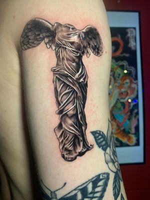 Experience the power of metallic elements with this striking black and gray illustrative tattoo of a chrome statue by the talented artist Manuel Arias.