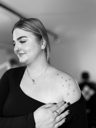 Get mesmerized by Vera's fine line star constellation tattoo that will illuminate your skin like the night sky. Perfect for stargazers and dreamers.
