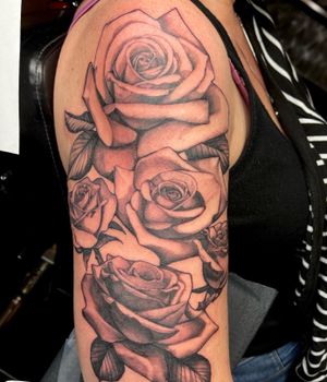 Roses half sleeve. Each rose represents a member in her family. 