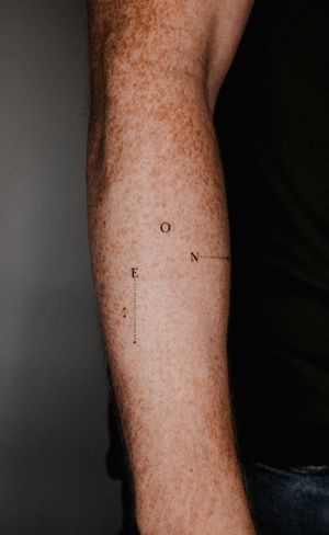 Express your unique style with this small lettering geometric tattoo design by the talented artist Gabriele Edu.