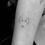 Experience the beauty of fine line art with this minimal pet tattoo of a dog outline by the talented artist Vera.