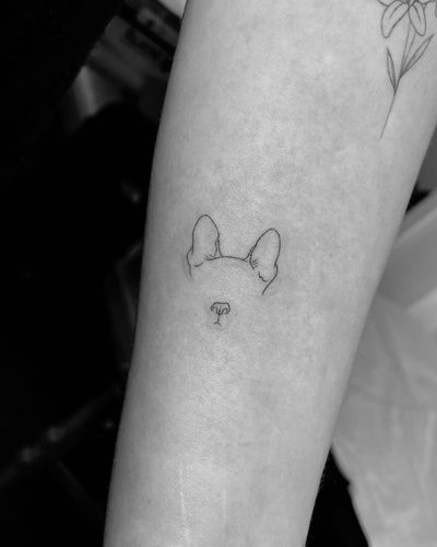 Experience the beauty of fine line art with this minimal pet tattoo of a dog outline by the talented artist Vera.