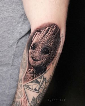 Baby groot black and grey realism tattoo