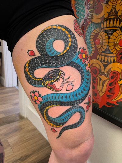 Get a striking traditional snake tattoo, expertly done by Laurel. Stand out with this bold and timeless design.