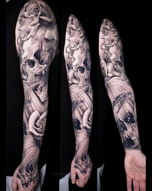 Full sleeve tattoo. Realism black and grey. Skulls, roses, turtle.