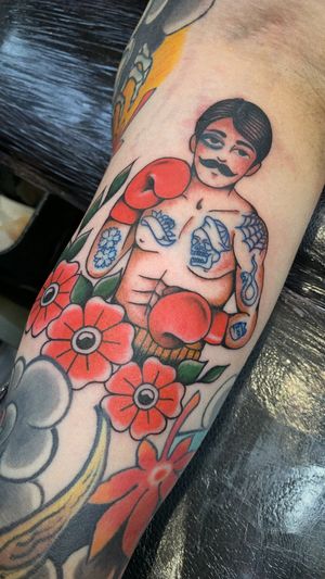Get inked with a classic traditional tattoo of a fighter or boxer, expertly crafted by Laurel.