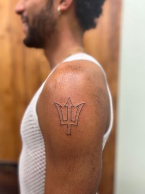 Unique fine line trident tattoo by Clayton Jeremiah, a blend of simplicity and intricate details.