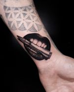 Bite the bullet micro realistic black and grey tattoo.
