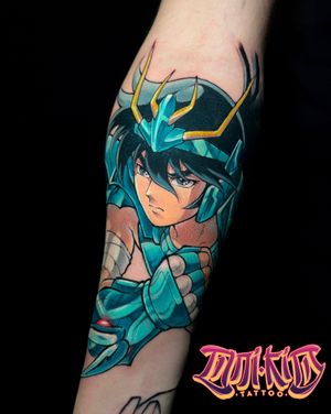 Get inked with this epic anime tattoo featuring Shiryu from Saint Seiya, designed by the talented artist Onikid.