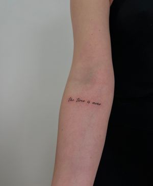 This fine line tattoo by Faith Llewellyn features small lettering with intricate details. Perfect for those seeking minimalist yet meaningful body art.