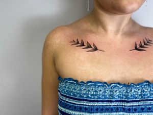 Capture the beauty of nature with this detailed laurel branch tattoo by Faith Llewellyn. Perfect for nature lovers!