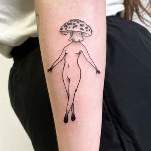 Explore the enchanting world of fine line and illustrative tattoos with this beautiful design by Jo Heatley, featuring a mystical mushroom and a serene woman.