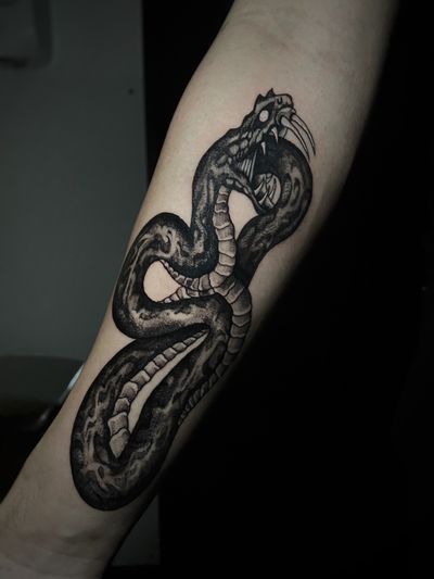 Embrace the mystique with this illustrative snake tattoo by artist Kike Krebs. Bold lines and intricate details create a striking blackwork design.